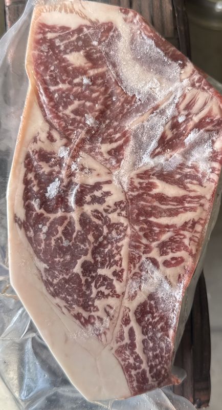 Close-up of a raw Akaushi Wagyu steak from our family farm with fine marbling