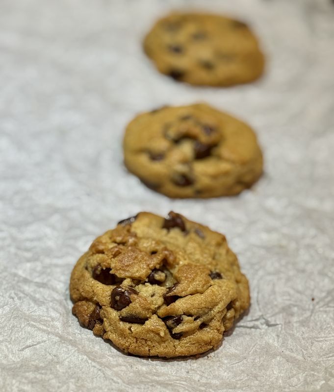 Brown butter chocolate chip cookies on parchment